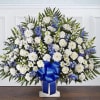 Floor basket arrangement of blue delphinium; white roses, snapdragons, ceremonies, carnations, daisy