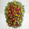 One-sided standing spray arrangement with orange roses and Asiatic lilies, golden sunflowers