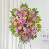 Pink and peach floral standing spray on an easel