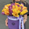 Bouquet of purple and yellow fringed tulips in a lavender hat box