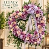 Heart-shaped rose wreath on an easel with a lavender ribbon