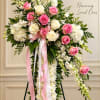 Standing floral spray with pink and white roses and white chrysanthemums on ribbons