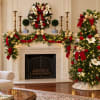 Christmas mantel and tree decorated with red and gold bows and white flowers