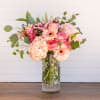 Pink and peach mixed bouquet in a clear glass vase