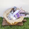 Gift basket with lavender-wrapped items and dried flowers