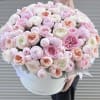 Large pastel bouquet of pink and white flowers in a round white box
