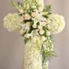White floral cross arrangement with cascading blooms