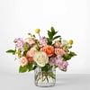Mixed pink and peach roses in a clear glass vase