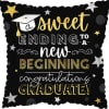 Graduation-themed decorative pillow with gold and white text on black background