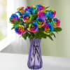 Bouquet of rainbow-colored roses in a purple glass vase