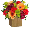 Colorful mixed bouquet in a wooden cube vase