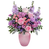 Pink and lavender flower arrangement in a pink vase