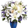 White lilies and daisies arranged in a blue vase