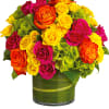 Bright mixed roses in a green glass vase