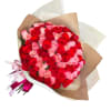 Bouquet of red and pink roses wrapped in brown paper with ribbon