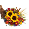 Sunflowers and mixed flowers arranged in a wicker cornucopia basket