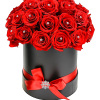 Red roses arranged in a black hatbox with a red ribbon