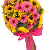 Bouquet of pink gerbera daisies and yellow sunflowers wrapped in brown paper with a pink ribbon