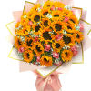 Bouquet of sunflowers and pink roses wrapped in pale pink paper