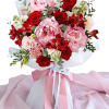 Bouquet of red roses and pink peonies wrapped with pink ribbon