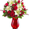 Red roses and white lilies in a red glass vase