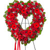Heart-shaped red rose wreath on a black easel with a red ribbon