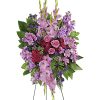 Standing spray of pink and purple flowers on a wire easel