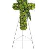 Green floral cross on a metal easel
