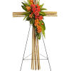 Floral cross on an easel with orange roses and greenery