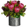 Pink protea bouquet in a ribbed metal vase