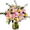 Pink lilies and roses in a clear glass vase with eucalyptus