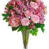 Pink rose and orchid bouquet in a clear glass vase