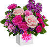 Pink and purple flower arrangement in a white box with ribbon