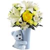 White lilies and yellow roses in a blue vase with a teddy bear
