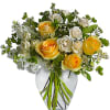 Yellow and white roses arranged in a clear glass vase