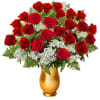 Red roses and white filler flowers in a gold vase