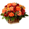 Orange and red flower arrangement in a wooden basket