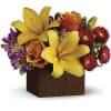 Yellow lilies and orange roses in a wooden cube vase with purple flowers