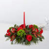 Red floral centerpiece with a tall candle and plaid ribbon