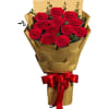 Bouquet of red roses wrapped in gold paper with a red ribbon