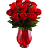 Red roses arranged in a red glass vase
