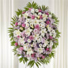 Large standing floral spray with pink, white, and lavender blooms