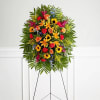 Standing floral spray with mixed bright flowers on an easel