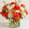Orange and white mixed bouquet in a clear glass vase