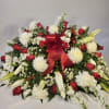 Large red, white, and yellow floral spray with a red ribbon bow