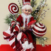 Christmas elf figurine in a red gift box with candy decorations