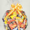 Basket of assorted snack bags wrapped in clear cellophane with a yellow ribbon