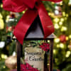 Decorative lantern with a red bow and a "Season's Greetings" holiday insert