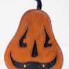 Wooden jack-o'-lantern decoration with a black stem