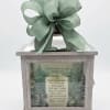 Wooden memorial box with a green bow and a grief message on the front